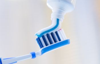 Toothbrush with Toothpaste Being Applied