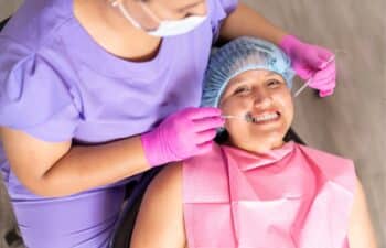 Dental professional examining patient's teeth during oral health checkup in Marietta, GA.