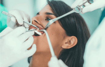 Dentist examining patient's teeth during emergency cosmetic dental treatment in Marietta.