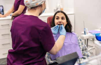 Dentist examining patient's teeth during dental checkup at Marietta practice.