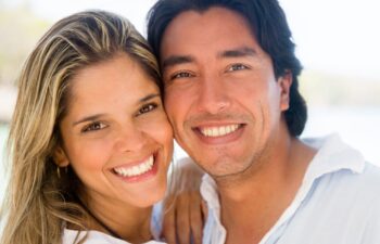 Happy couple smiling together after successful tooth-colored filling treatment in Marietta.