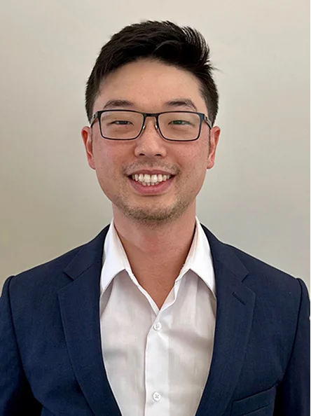 Dr. Daniel H. Lee wearing glasses and a dark shirt, smiling at the camera.